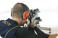 man shooting benchrest rifle